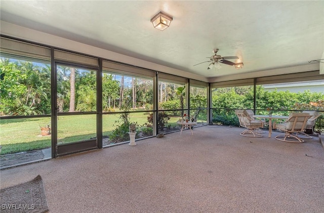 unfurnished sunroom featuring ceiling fan