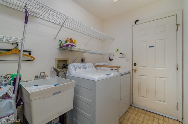 laundry room featuring independent washer and dryer and sink