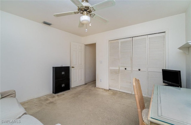 office with ceiling fan and light carpet