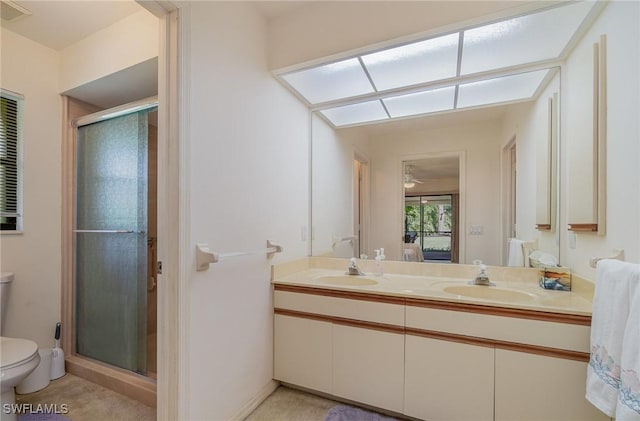 bathroom with an enclosed shower, vanity, and toilet