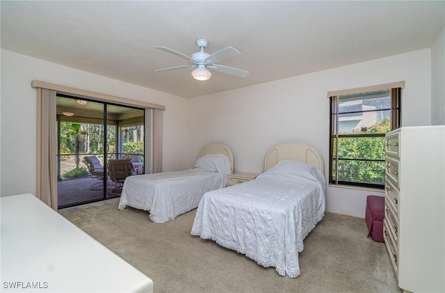 carpeted bedroom featuring multiple windows, access to outside, and ceiling fan