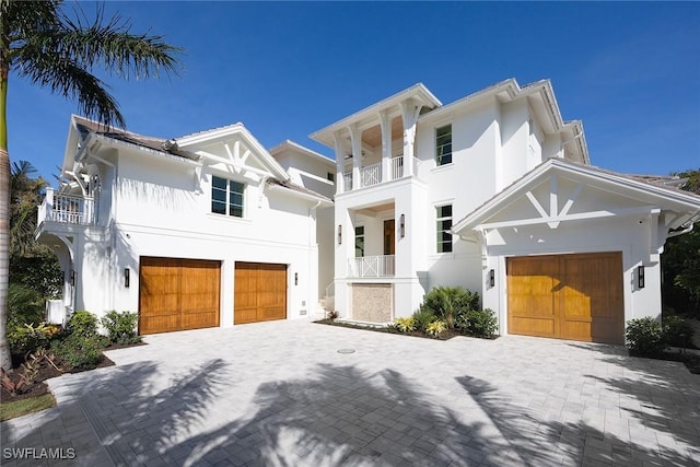 view of front of house featuring a garage and a balcony