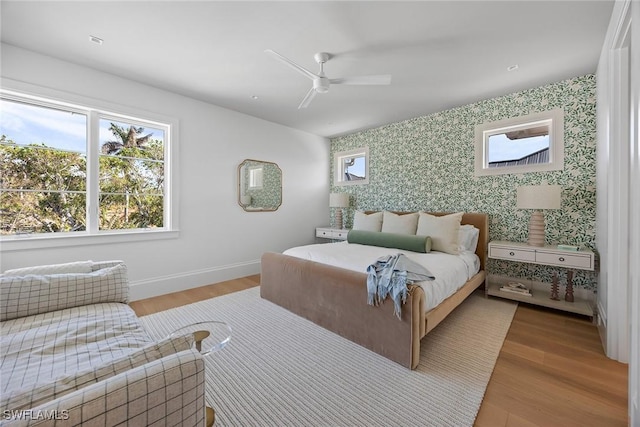 bedroom with ceiling fan and light wood-type flooring