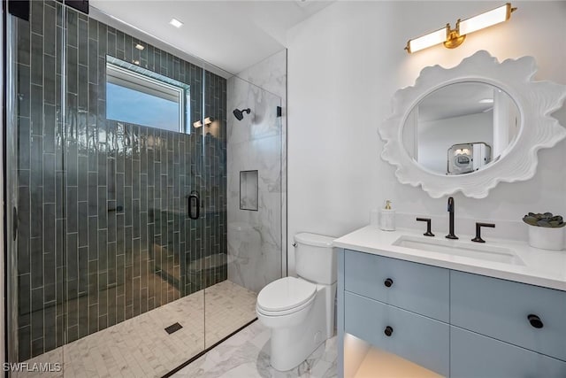 bathroom featuring vanity, toilet, and a shower with shower door