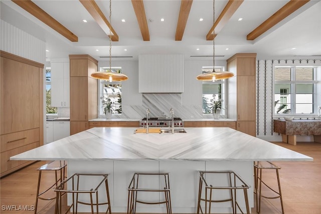 kitchen with a healthy amount of sunlight, a spacious island, and hanging light fixtures