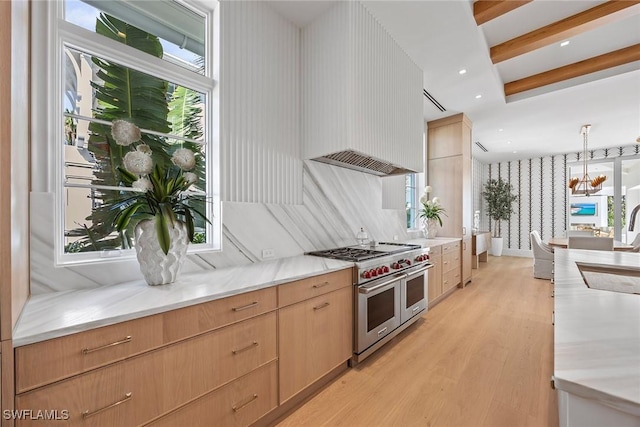 kitchen featuring light brown cabinets, beamed ceiling, double oven range, decorative light fixtures, and light wood-type flooring