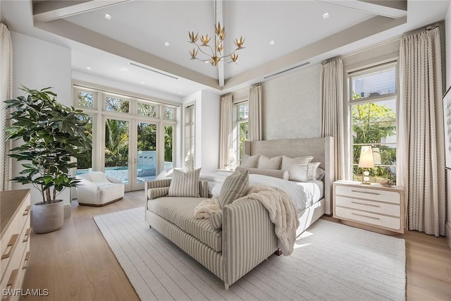 bedroom featuring light hardwood / wood-style flooring, access to outside, and multiple windows