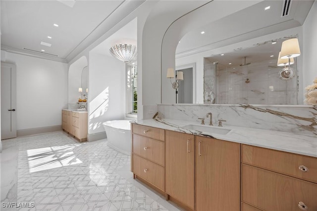 bathroom featuring crown molding, vanity, and independent shower and bath