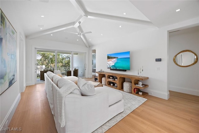 living room with ceiling fan, lofted ceiling with beams, and light wood-type flooring