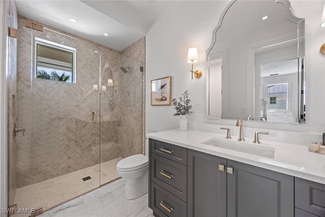 bathroom featuring vanity, toilet, and walk in shower