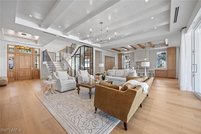 living room featuring a chandelier, beam ceiling, and light wood-type flooring