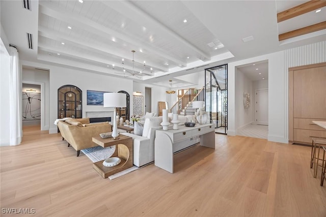 living room with beam ceiling and light wood-type flooring