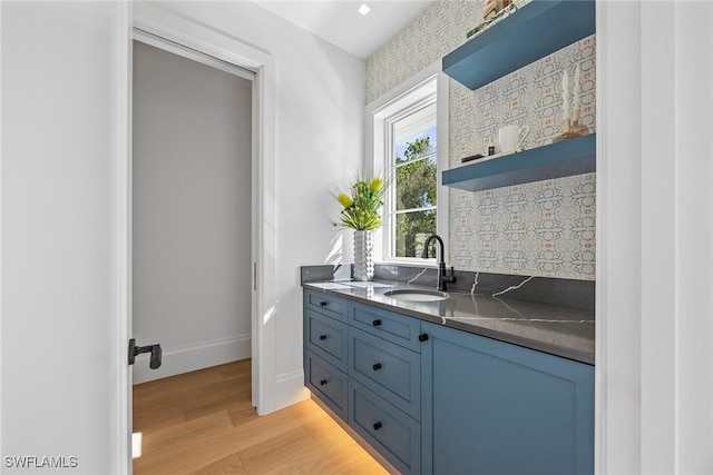 bathroom with tasteful backsplash, hardwood / wood-style floors, and vanity