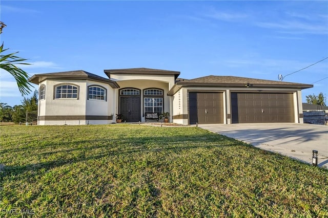 view of front of property with a front yard and a garage