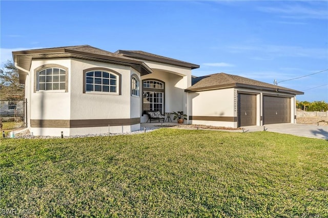 view of front of home with a front yard and a garage