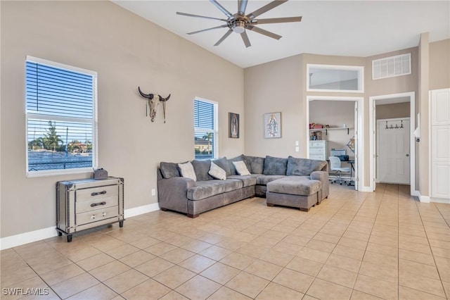 tiled living room featuring a high ceiling and ceiling fan