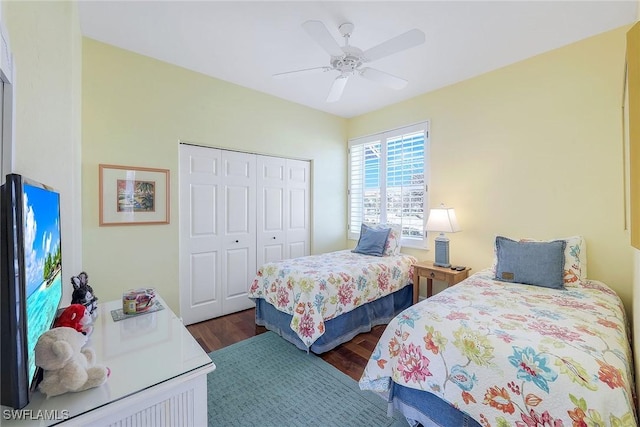 bedroom with dark hardwood / wood-style flooring, a closet, and ceiling fan