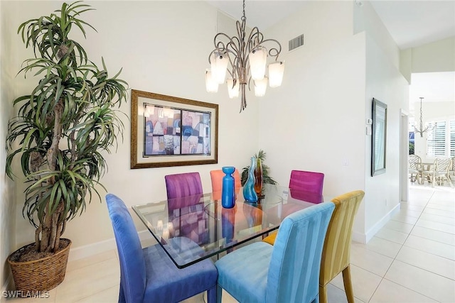 dining space with light tile patterned flooring, high vaulted ceiling, and an inviting chandelier