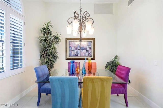 dining space featuring light tile patterned floors and a notable chandelier