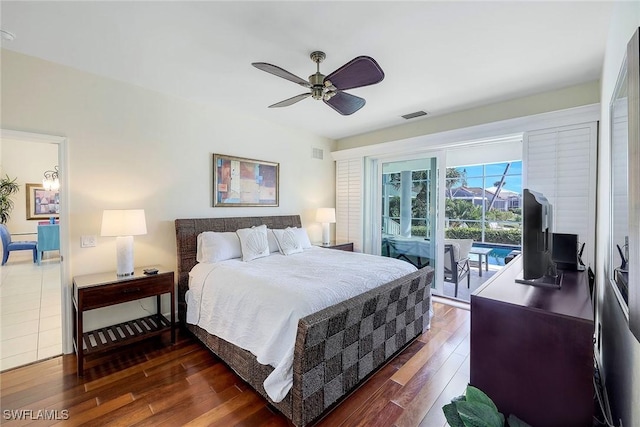 bedroom with access to outside, ceiling fan, and dark wood-type flooring