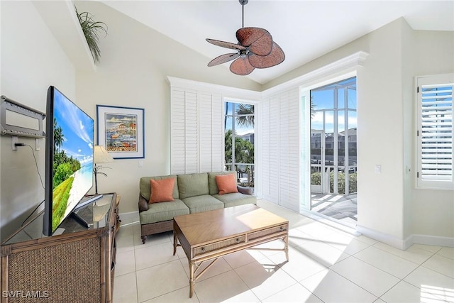 tiled living room featuring ceiling fan and lofted ceiling