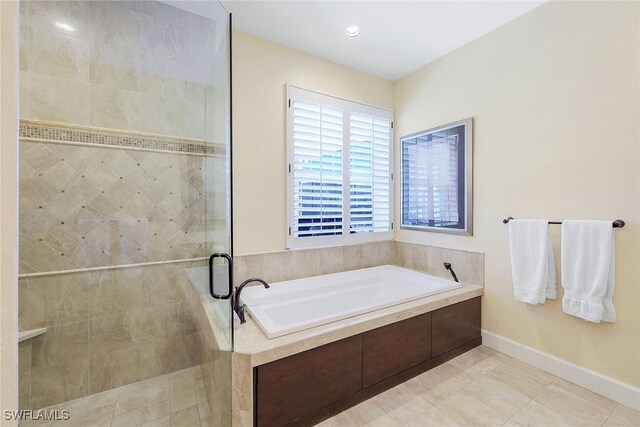 bathroom featuring tile patterned floors and independent shower and bath