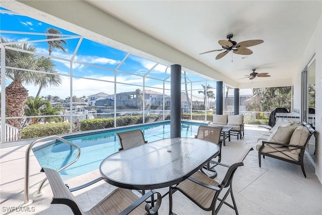 view of patio / terrace with ceiling fan, a lanai, and an outdoor living space