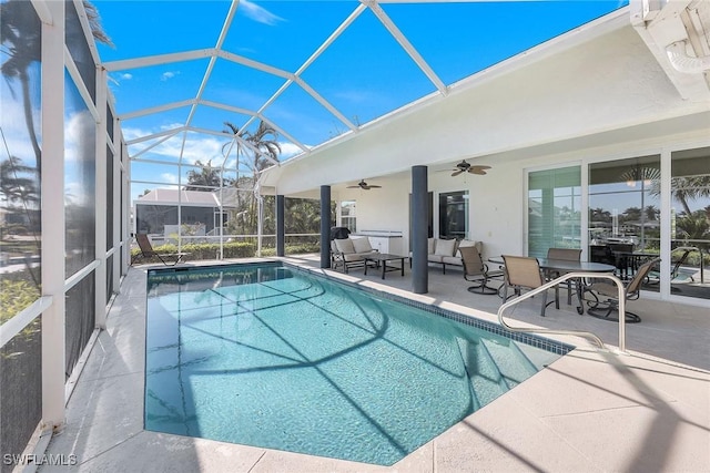 view of swimming pool featuring a lanai, outdoor lounge area, and a patio