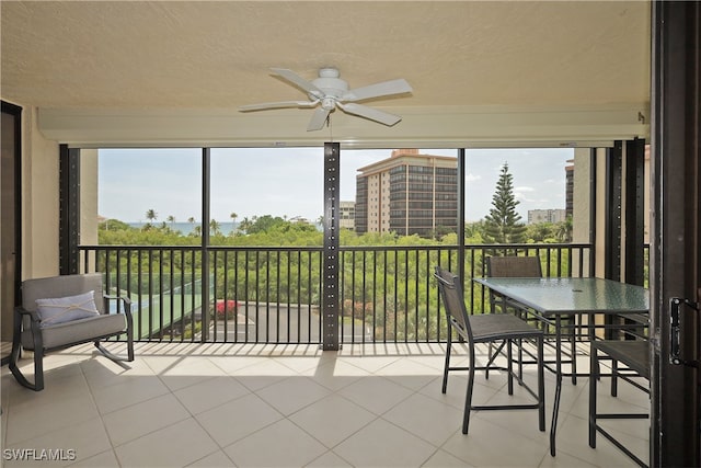 sunroom / solarium featuring ceiling fan