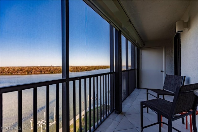 unfurnished sunroom featuring a water view