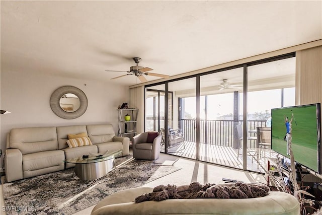 living room with a wall of windows and ceiling fan