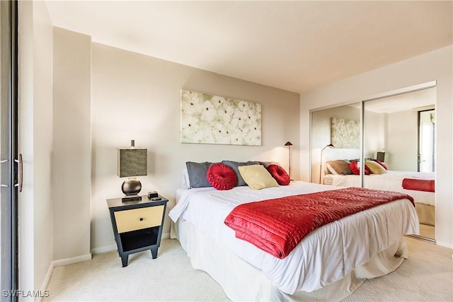 bedroom featuring light carpet and a closet