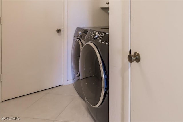 laundry room with tile patterned floors and washer and clothes dryer