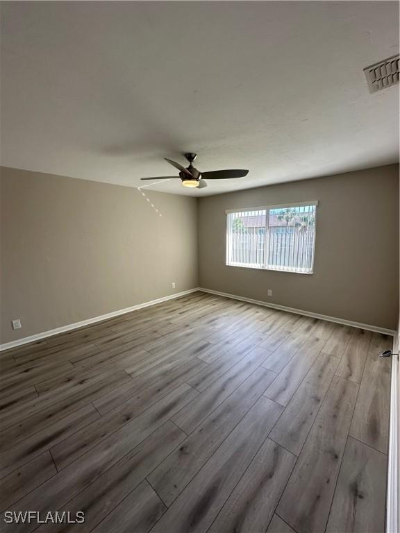 unfurnished room with light hardwood / wood-style flooring and ceiling fan