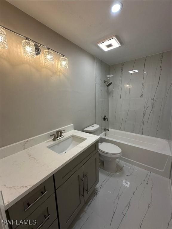 full bathroom with toilet, vanity, and tiled shower / bath