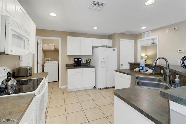 kitchen with white appliances, white cabinets, sink, light tile patterned floors, and washer / dryer