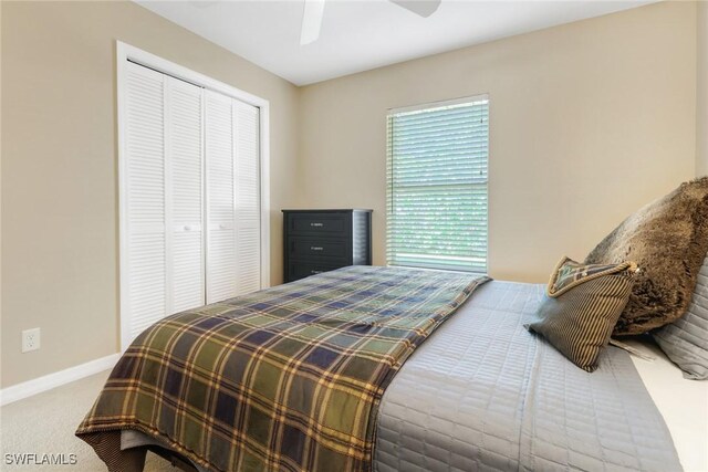 bedroom with carpet flooring, ceiling fan, and a closet