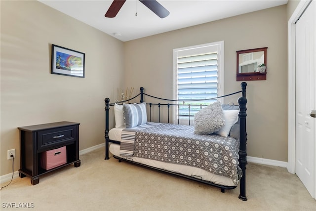 carpeted bedroom featuring ceiling fan and a closet