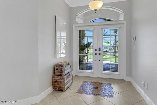 entryway with french doors, light tile patterned flooring, and a healthy amount of sunlight