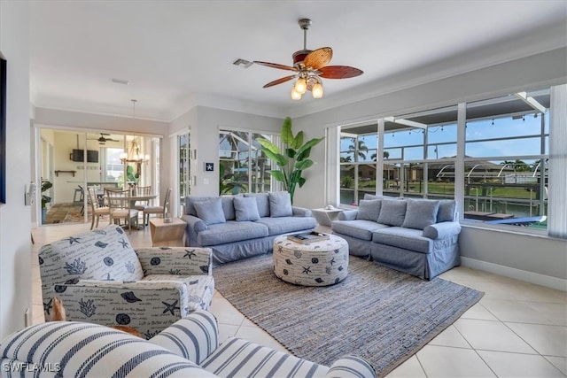 living room featuring a wealth of natural light, light tile patterned floors, and ornamental molding