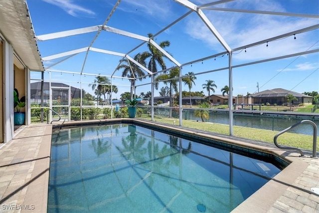 view of pool with a water view and a lanai