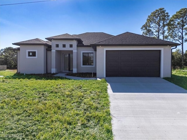 prairie-style home featuring a garage and a front yard