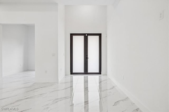1436 Graham Cir, Lehigh Acres, FL 33936 - empty room with marble finish floor, baseboards, and french doors