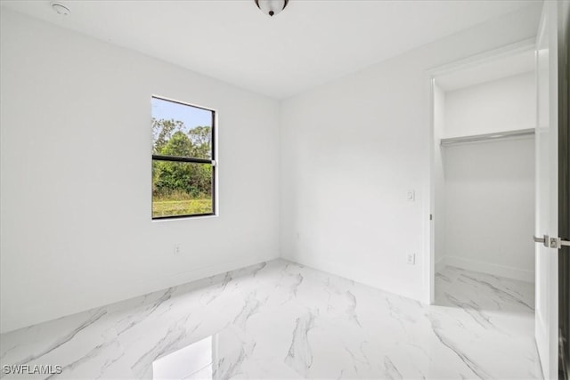 1436 Graham Cir, Lehigh Acres, FL 33936 - unfurnished bedroom featuring marble finish floor and a closet