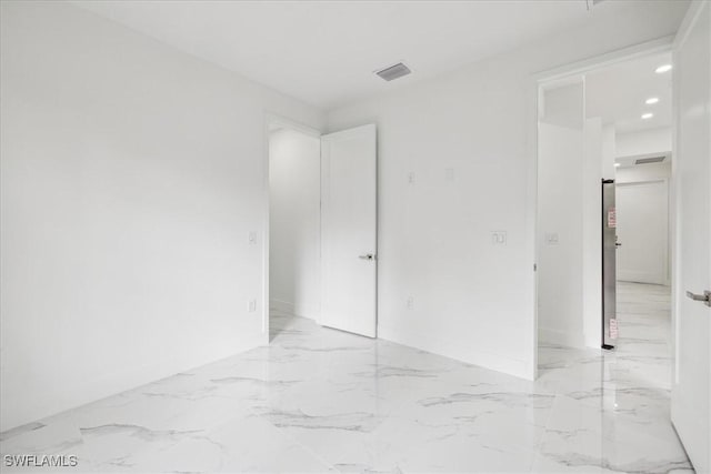 1436 Graham Cir, Lehigh Acres, FL 33936 - unfurnished room with visible vents and marble finish floor