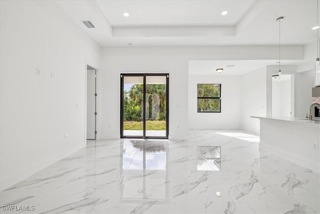 unfurnished room with a raised ceiling