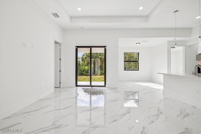 1436 Graham Cir, Lehigh Acres, FL 33936 - unfurnished living room featuring recessed lighting, marble finish floor, a tray ceiling, visible vents, and baseboards