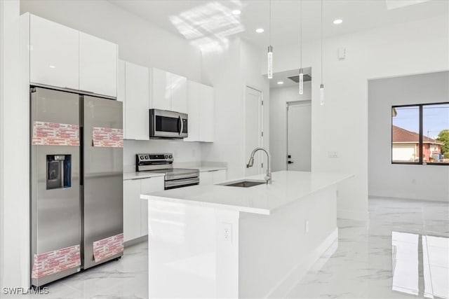 kitchen with white cabinetry, sink, a center island with sink, and appliances with stainless steel finishes