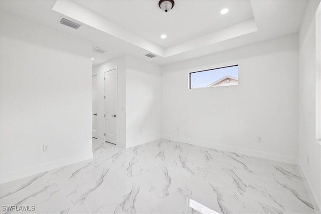 spare room featuring a tray ceiling