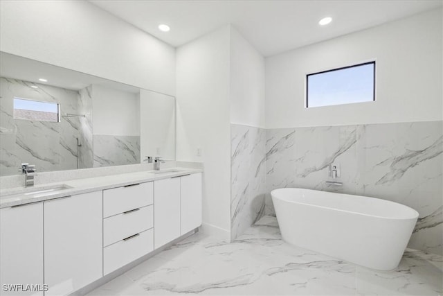 bathroom with separate shower and tub, vanity, and a healthy amount of sunlight